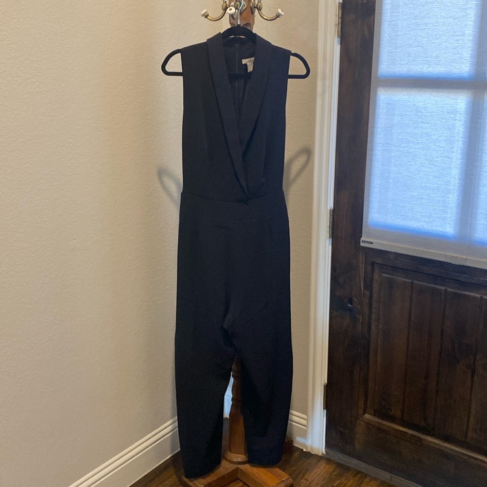 Black v neck , sleeveless jumper, zip back, tie waist with pockets( not seen)